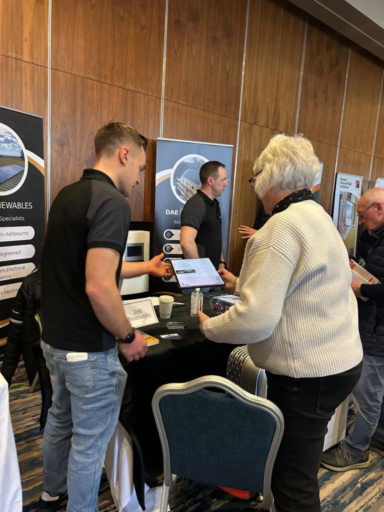 Andrew from the DAE renewable team discussing solar with a lady at the SEAI home energy show.